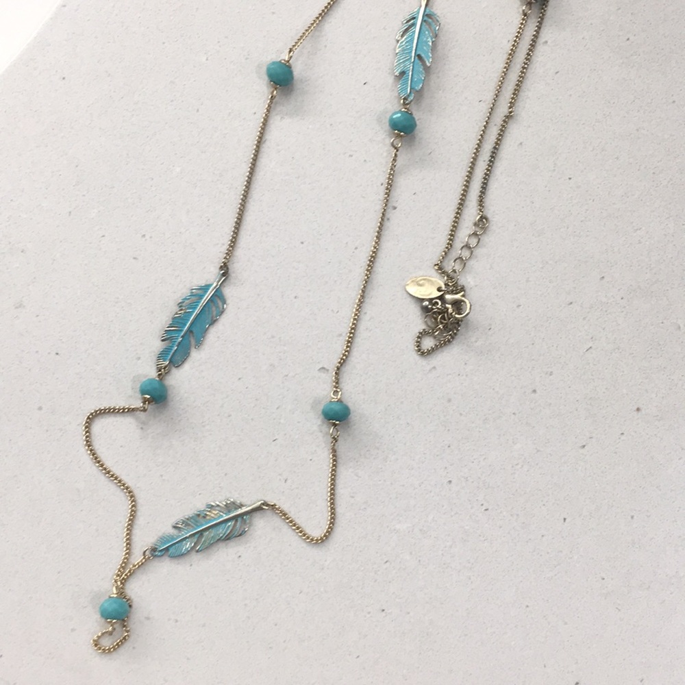 Long gold and turquoise necklace; feather motif.